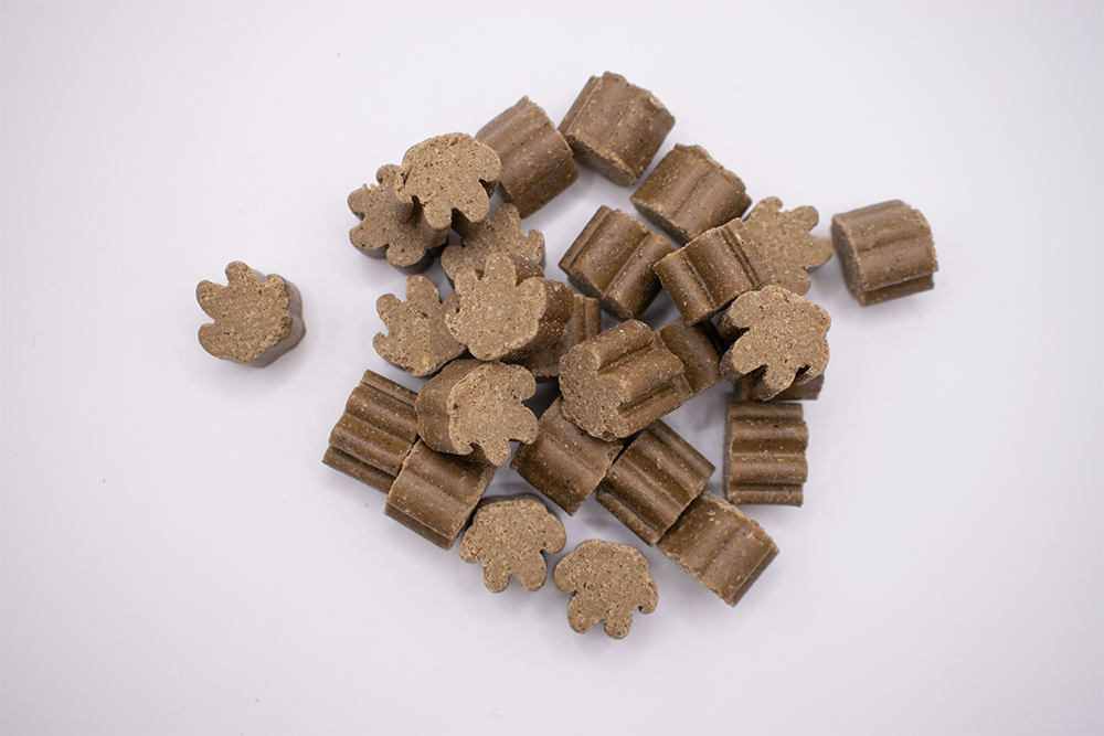 Loose AniVatio soft chews — paw and bone shaped supplement chews from the production line